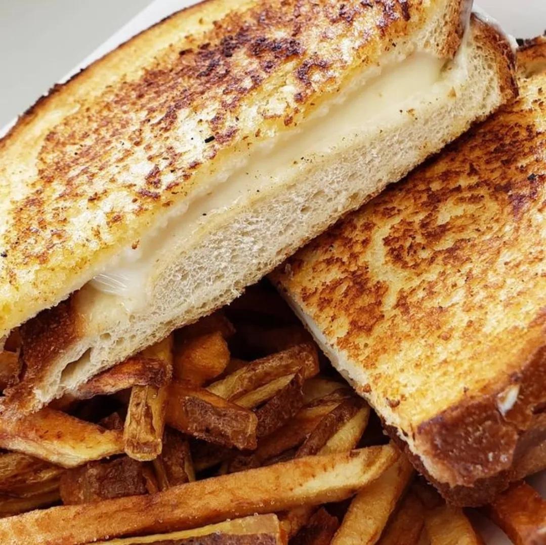 Grilled cheese halves served with seasoned fries