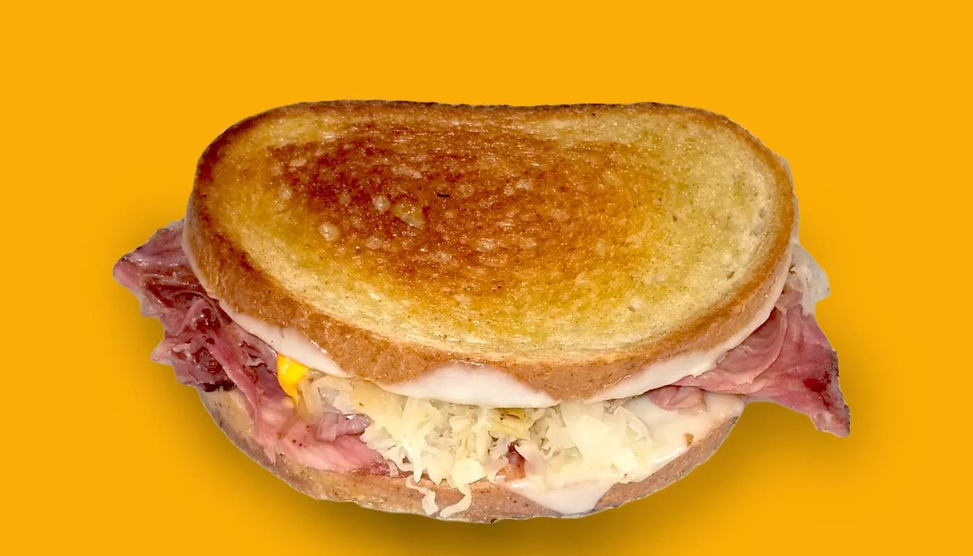 Reuben grilled cheese with corned beef, sauerkraut and melted Swiss on toasted rye